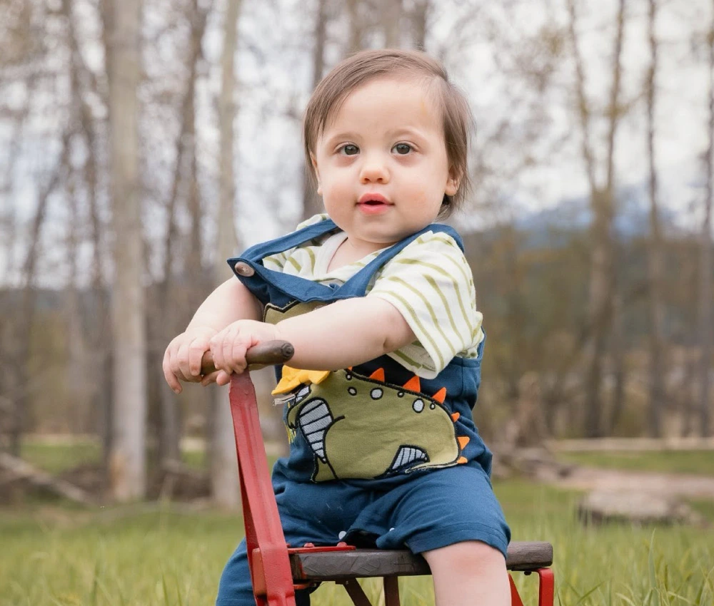 Sawyer Phoenix outside on riding toy