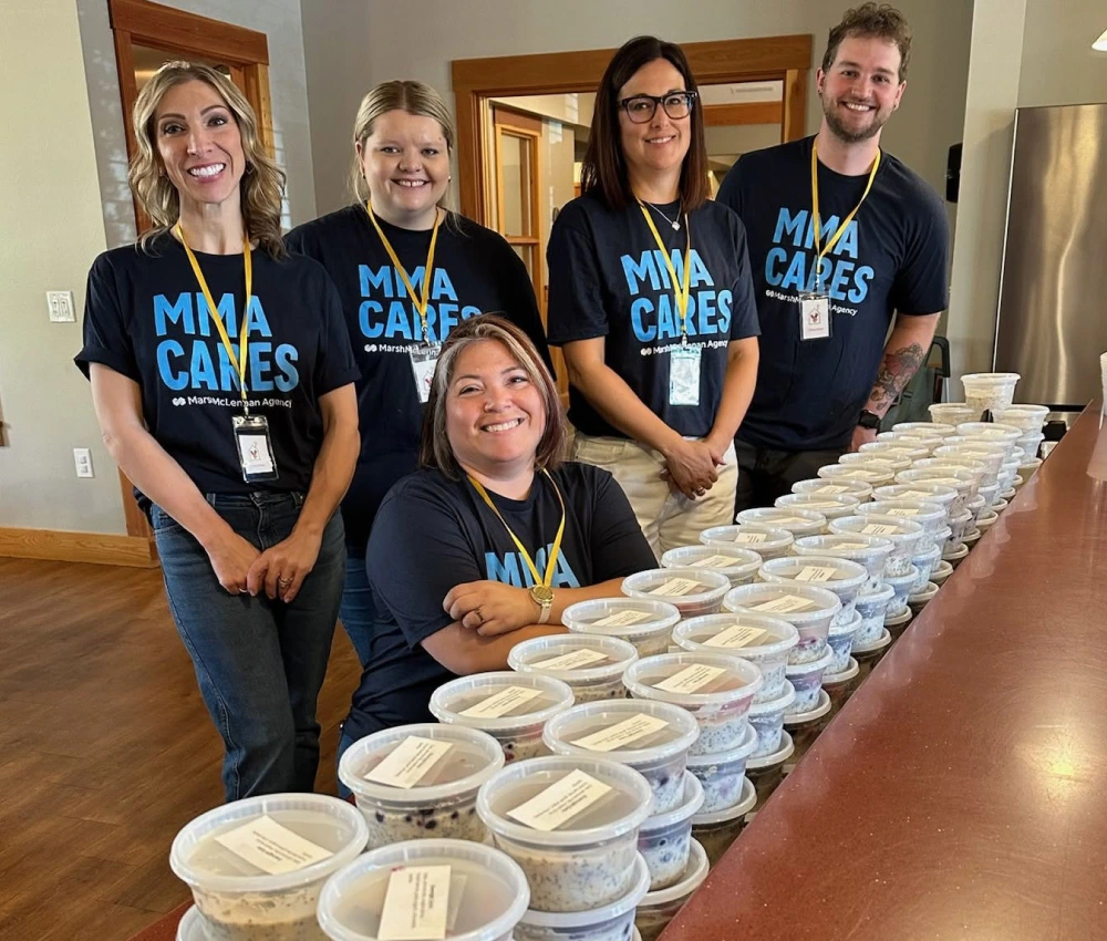 group of volunteers with prepared packaged breakfasts for our families