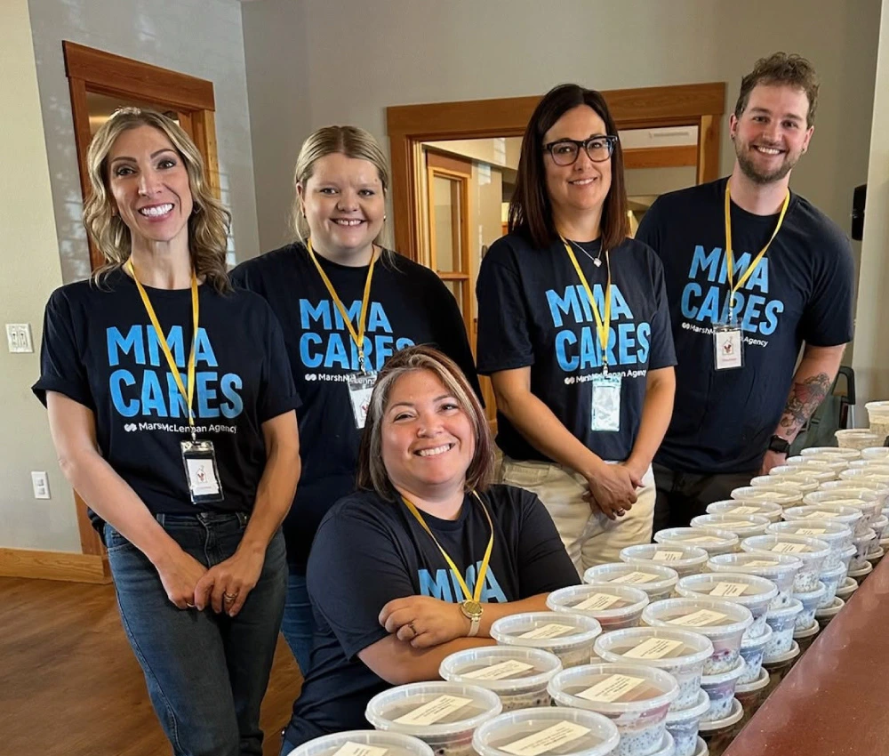 group of volunteers with prepared packaged breakfasts for our families