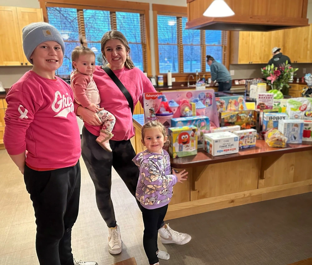 A family in matching colors with a large donation for our house