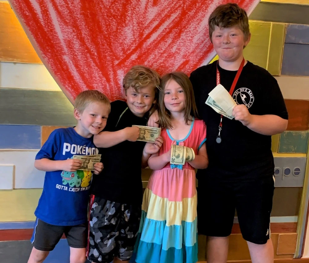 group of young kids with donations for our programs